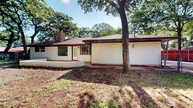 2350 Ravenwood Dr, Grand Prairie, TX 75050 - view of front of property featuring a chimney, a patio area, a gate, and brick siding