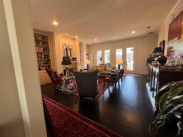 3921 Salem Ct, Plano, TX 75023 - living room featuring dark wood-style floors, built in features, a decorative wall, and french doors