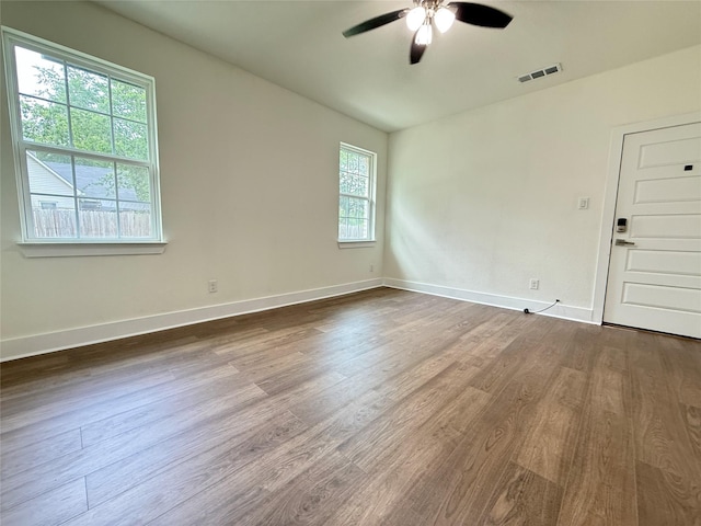 201 E 10th St, Kaufman, TX 75142 - empty room featuring dark wood-type flooring, ceiling fan, and baseboards