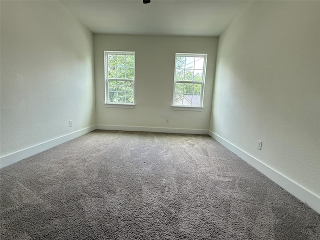201 E 10th St, Kaufman, TX 75142 - carpeted spare room featuring baseboards and a textured wall