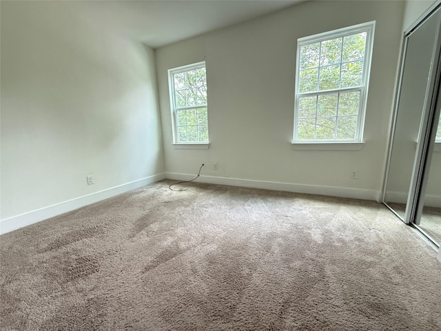 201 E 10th St, Kaufman, TX 75142 - spare room featuring baseboards and carpet flooring