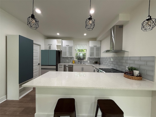 201 E 10th St, Kaufman, TX 75142 - kitchen with wall chimney exhaust hood, a peninsula, dishwasher, freestanding refrigerator, and backsplash
