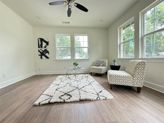 201 E 10th St, Kaufman, TX 75142 - living area with wood finished floors, baseboards, and a ceiling fan