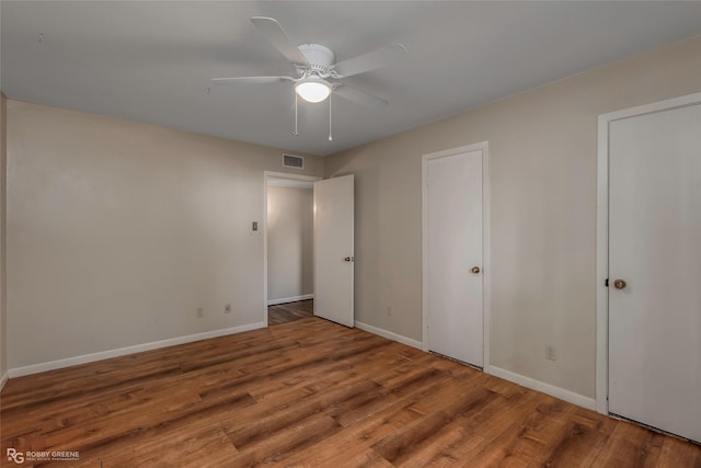 3820 Fairfield Ave Unit 113, Shreveport, LA 71104 - unfurnished bedroom with wood finished floors, baseboards, and a ceiling fan