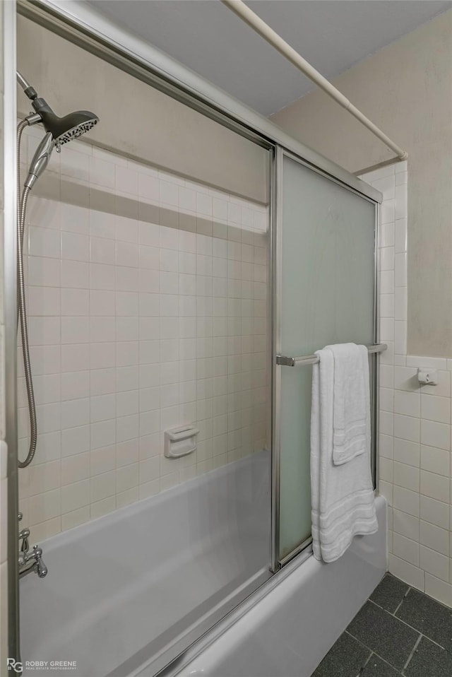 3820 Fairfield Ave Unit 113, Shreveport, LA 71104 - full bath featuring combined bath / shower with glass door, tile patterned floors, and tile walls