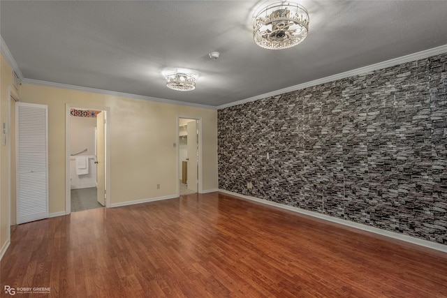 3820 Fairfield Ave Unit 113, Shreveport, LA 71104 - empty room featuring a chandelier, ornamental molding, wood finished floors, and baseboards