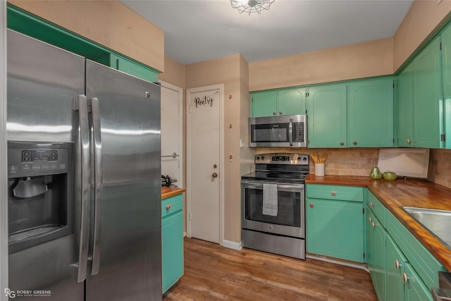3820 Fairfield Ave Unit 113, Shreveport, LA 71104 - kitchen with appliances with stainless steel finishes, green cabinetry, butcher block counters, and backsplash