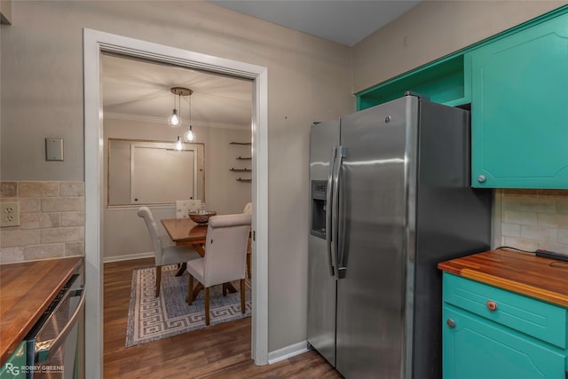 3820 Fairfield Ave Unit 113, Shreveport, LA 71104 - kitchen featuring butcher block counters, stainless steel fridge, wood finished floors, ornamental molding, and backsplash