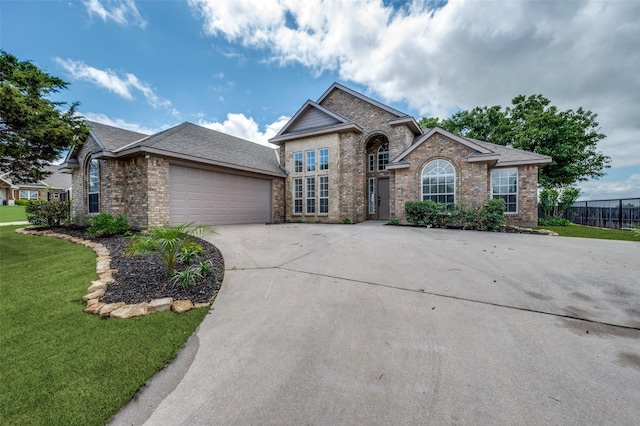 212 Cory Ct, Krum, TX 76249 - view of front of home featuring brick siding, a garage, and driveway