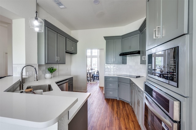 212 Cory Ct, Krum, TX 76249 - kitchen featuring appliances with stainless steel finishes, a sink, a peninsula, and plenty of natural light