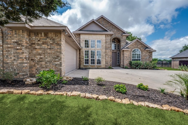 212 Cory Ct, Krum, TX 76249 - view of front of house with a garage, brick siding, and driveway