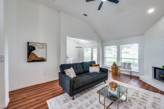212 Cory Ct, Krum, TX 76249 - living room featuring wood finished floors, vaulted ceiling, a ceiling fan, a brick fireplace, and baseboards