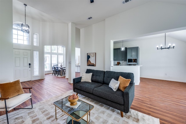 212 Cory Ct, Krum, TX 76249 - living area featuring a chandelier, high vaulted ceiling, wood finished floors, and baseboards