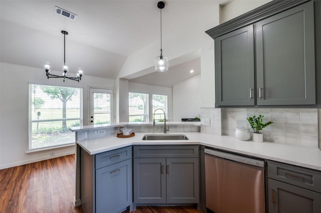 212 Cory Ct, Krum, TX 76249 - kitchen with stainless steel dishwasher, a sink, a peninsula, vaulted ceiling, and tasteful backsplash
