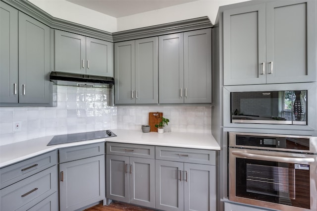 212 Cory Ct, Krum, TX 76249 - kitchen with oven, gray cabinetry, black electric cooktop, and built in microwave