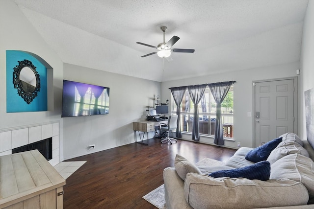 4408 Sunny Oak Ln, Corinth, TX 76208 - living area with ceiling fan, wood finished floors, a fireplace, lofted ceiling, and a textured ceiling