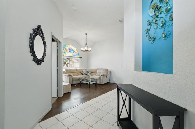 4408 Sunny Oak Ln, Corinth, TX 76208 - hall featuring vaulted ceiling, a textured wall, a chandelier, and wood finished floors