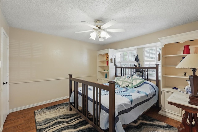 2739 Timberleaf Dr, Carrollton, TX 75006 - bedroom featuring dark wood-type flooring, ceiling fan, a textured ceiling, and baseboards