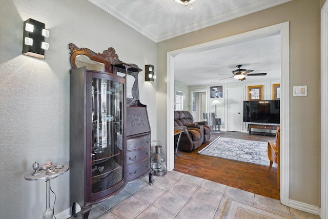2739 Timberleaf Dr, Carrollton, TX 75006 - entrance foyer featuring ornamental molding, tile patterned floors, a textured ceiling, ceiling fan, and baseboards