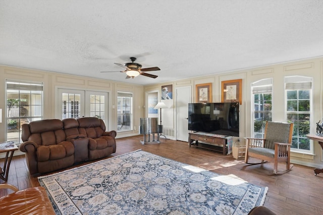2739 Timberleaf Dr, Carrollton, TX 75006 - living room featuring a decorative wall, ceiling fan, wood finished floors, and a textured ceiling