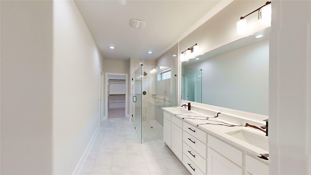 6857 Rutland Dr, Arlington, TX 76002 - bathroom featuring a shower stall, double vanity, recessed lighting, baseboards, and a walk in closet