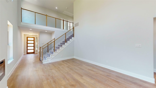 6857 Rutland Dr, Arlington, TX 76002 - entrance foyer featuring stairway, light wood-type flooring, baseboards, and a towering ceiling