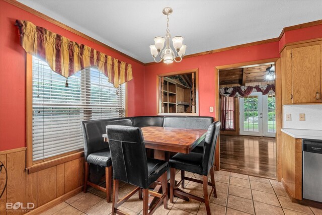 2020 Venus Dr, Bossier City, LA 71112 - dining room featuring a chandelier, wainscoting, and light tile patterned floors