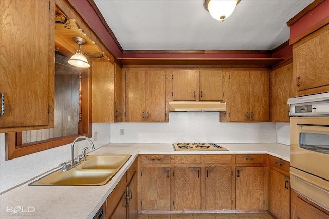2020 Venus Dr, Bossier City, LA 71112 - kitchen with under cabinet range hood, white appliances, a warming drawer, light countertops, and a sink