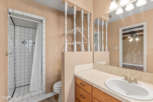 2020 Venus Dr, Bossier City, LA 71112 - bathroom with a shower stall, vanity, toilet, a ceiling fan, and tile patterned floors