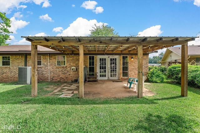 2020 Venus Dr, Bossier City, LA 71112 - back of property featuring central AC unit, french doors, a patio, and a lawn