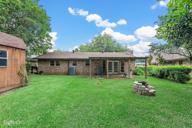 2020 Venus Dr, Bossier City, LA 71112 - rear view of house featuring french doors, an outdoor fire pit, a patio area, a lawn, and brick siding
