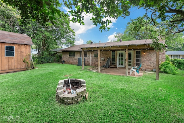 2020 Venus Dr, Bossier City, LA 71112 - rear view of property with an outdoor fire pit, a patio area, a yard, and brick siding