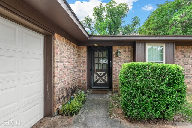 2020 Venus Dr, Bossier City, LA 71112 - entrance to property with an attached garage and brick siding