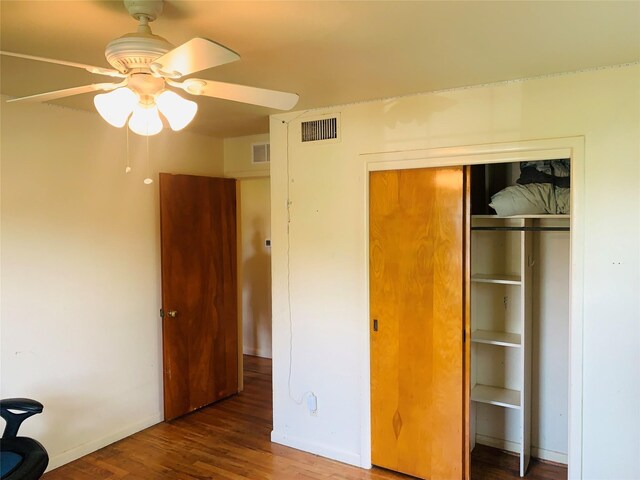 2009 W Way, Garland, TX 75042 - unfurnished bedroom featuring a closet, wood finished floors, baseboards, and ceiling fan