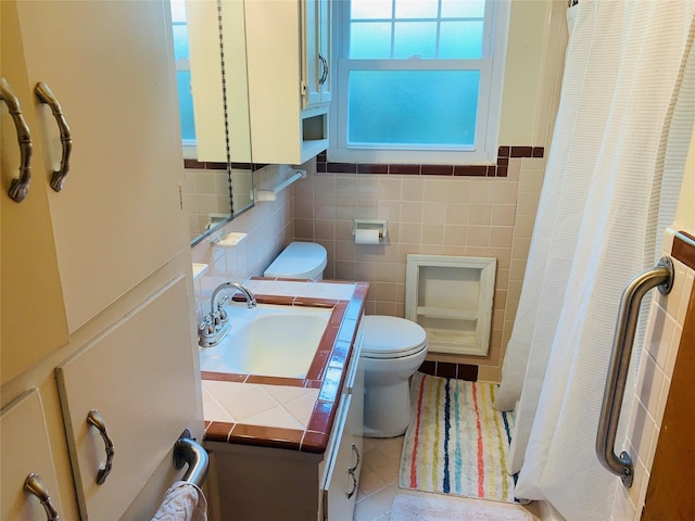 2009 W Way, Garland, TX 75042 - bathroom with toilet, tile walls, vanity, a shower with shower curtain, and tile patterned floors