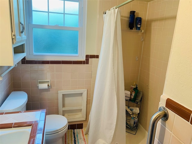 2009 W Way, Garland, TX 75042 - full bathroom with tile walls, toilet, and a shower with curtain
