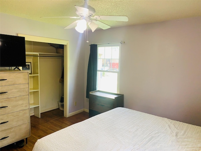2009 W Way, Garland, TX 75042 - bedroom featuring dark wood-type flooring, a closet, a ceiling fan, a textured ceiling, and baseboards