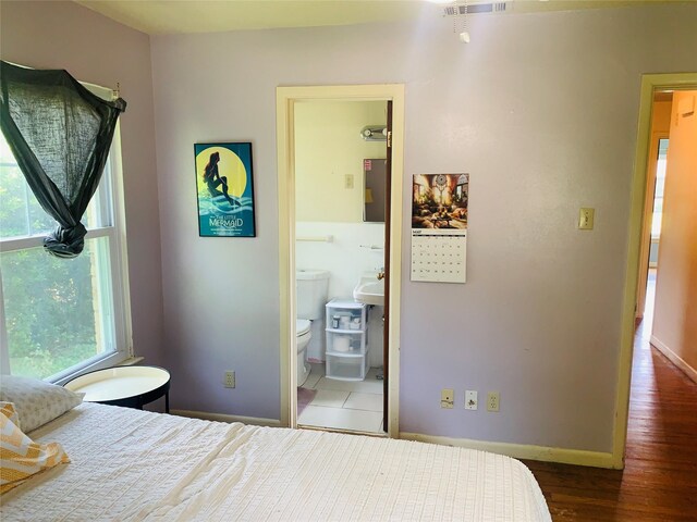 2009 W Way, Garland, TX 75042 - bedroom with baseboards and wood finished floors