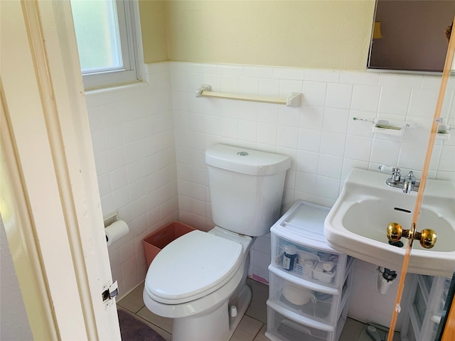 2009 W Way, Garland, TX 75042 - bathroom featuring tile walls, toilet, a wainscoted wall, and a sink