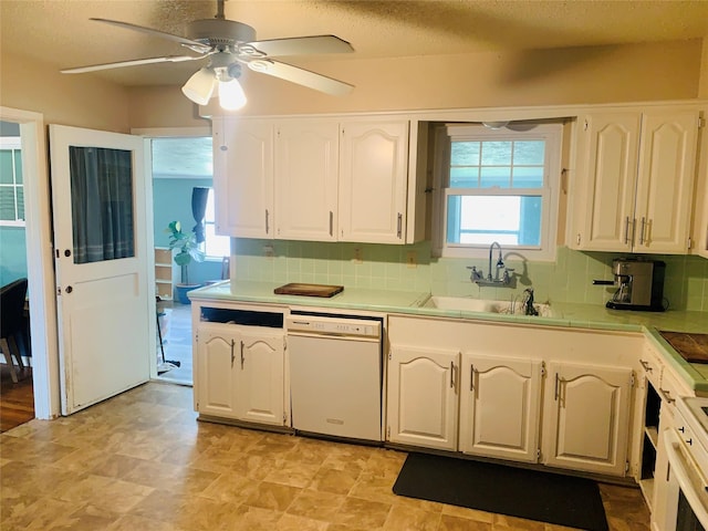 2009 W Way, Garland, TX 75042 - kitchen with white dishwasher, white cabinets, ceiling fan, and a sink
