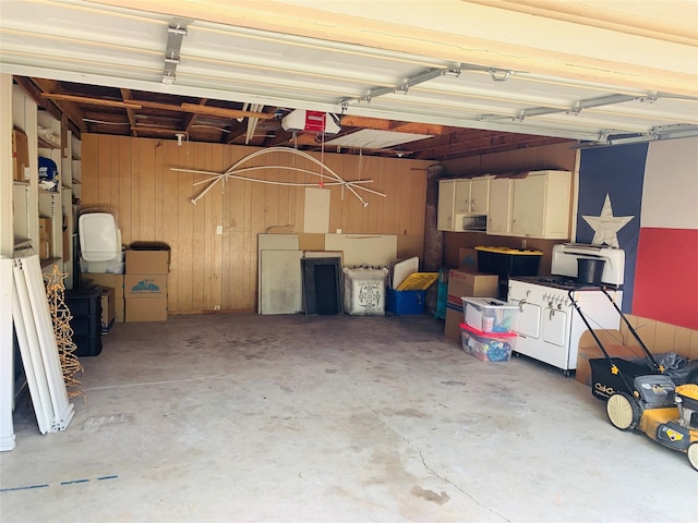 2009 W Way, Garland, TX 75042 - garage with wood walls and a garage door opener