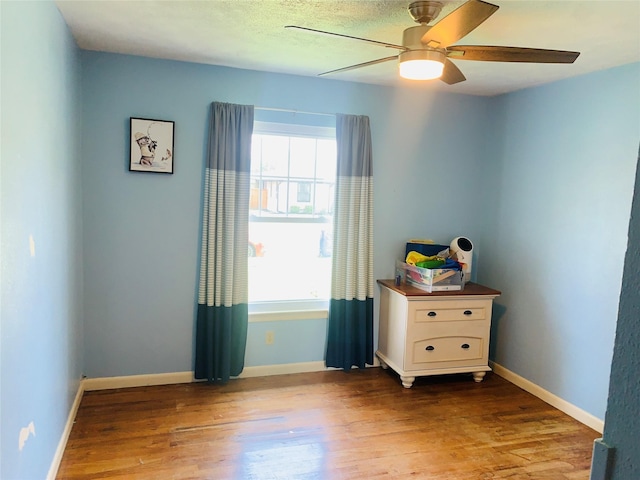 2009 W Way, Garland, TX 75042 - bedroom featuring wood finished floors, a ceiling fan, and baseboards