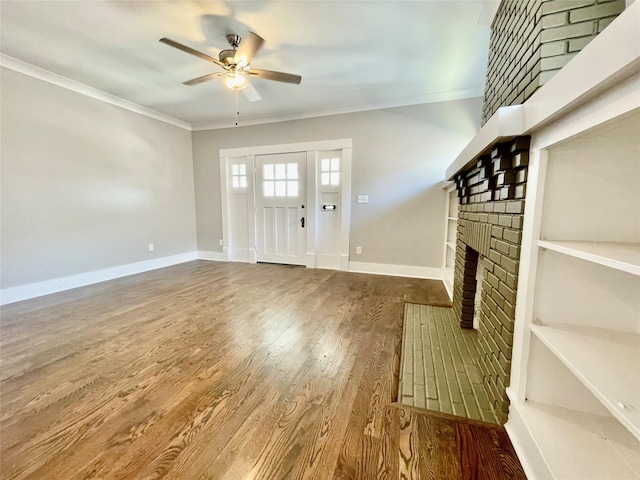 714 Beacon, Dallas, TX 75214 - foyer entrance featuring a brick fireplace, a ceiling fan, crown molding, wood finished floors, and baseboards