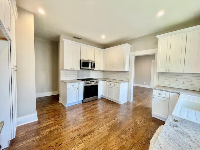 714 Beacon, Dallas, TX 75214 - kitchen featuring stainless steel appliances, baseboards, backsplash, light stone counters, and white cabinets