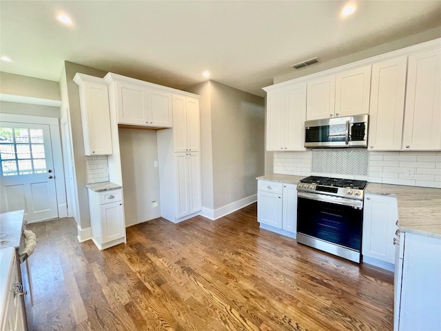 714 Beacon, Dallas, TX 75214 - kitchen with stainless steel appliances, decorative backsplash, white cabinetry, wood finished floors, and recessed lighting