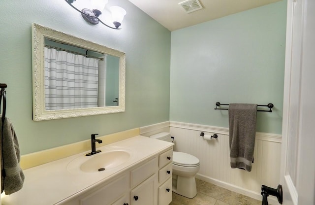 1320 Cedar Branch Dr, Wylie, TX 75098 - bathroom featuring vanity, toilet, a wainscoted wall, tile patterned flooring, and a shower with shower curtain