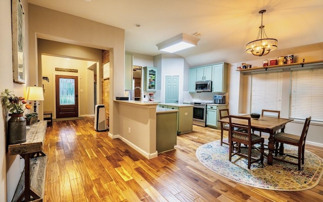 1320 Cedar Branch Dr, Wylie, TX 75098 - kitchen featuring appliances with stainless steel finishes, light wood-style floors, a chandelier, and light countertops