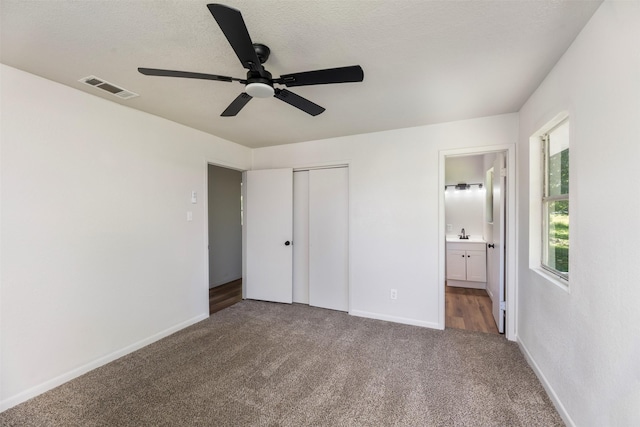 103 Ivy St, Kerens, TX 75144 - unfurnished bedroom featuring carpet, baseboards, a closet, ensuite bathroom, and a sink