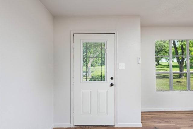 103 Ivy St, Kerens, TX 75144 - doorway featuring plenty of natural light, baseboards, and wood finished floors