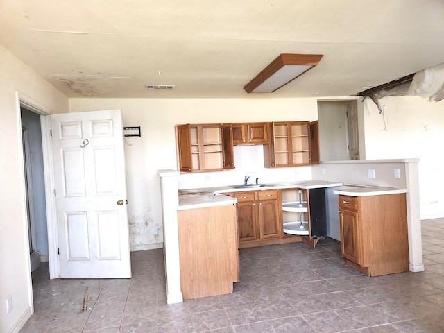 180 Shady Shores Dr, Mabank, TX 75156 - kitchen with a sink, open shelves, brown cabinetry, baseboards, and light countertops